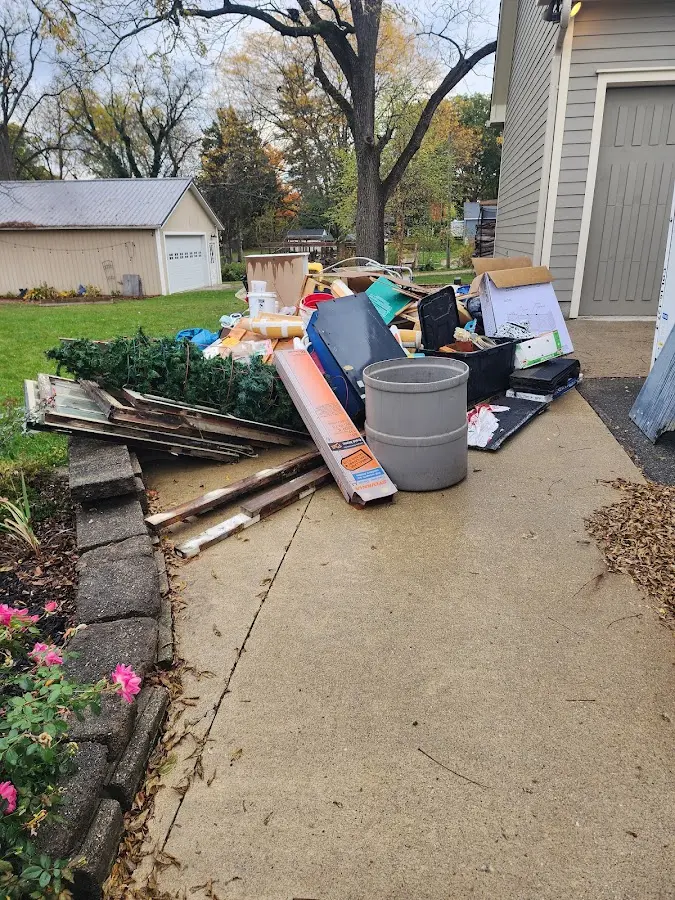 Dumpster being loaded with debris for 12 Yard Dumpster Rental in Karns